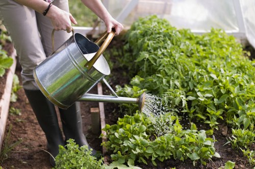 Compost bays and volunteers turning garden trimmings into soil in Dalston.